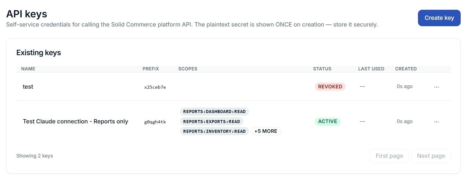 API Keys list showing a reports-only key with assigned scopes and Active status, alongside a revoked key.