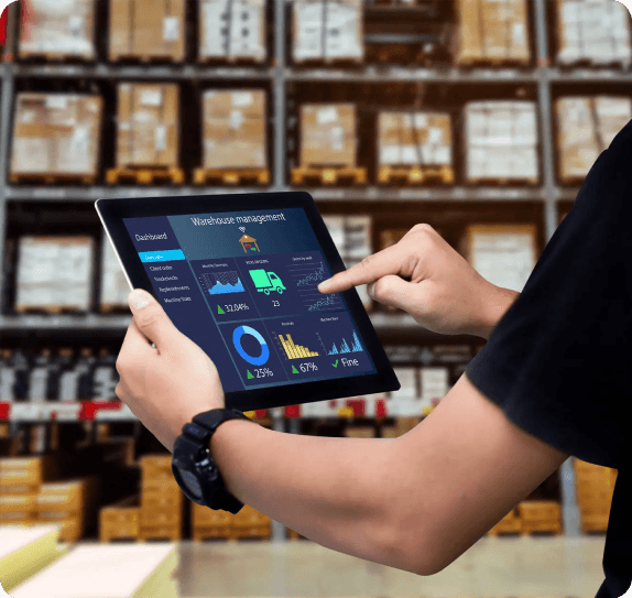 Warehouse operations dashboard displayed on a tablet in front of fulfillment shelves.